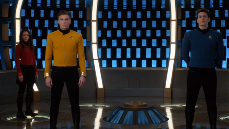 Pike and a few of his officers beam aboard the Discovery in their fancy new uniforms.